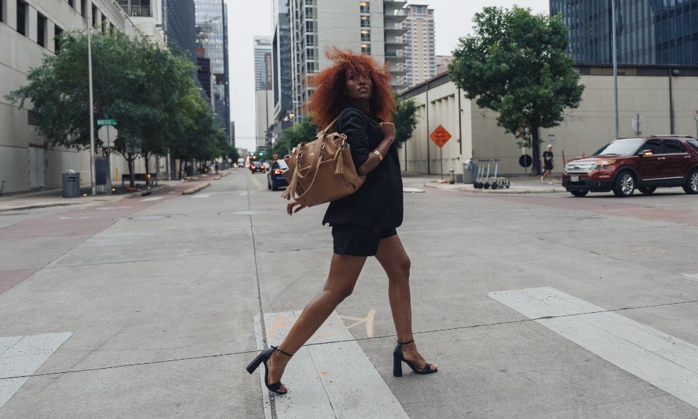 Gemini Mini Convertible Backpack by White Elm modeled on city street worn as a backpack