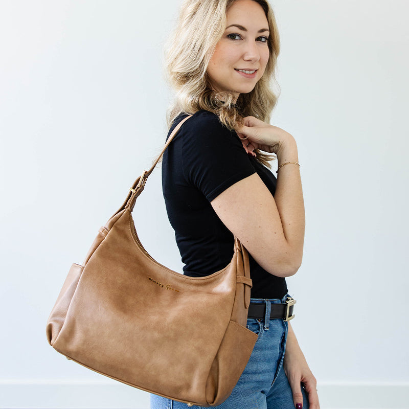 Almond Camille hobo bag worn over the shoulder with the strap shortened
