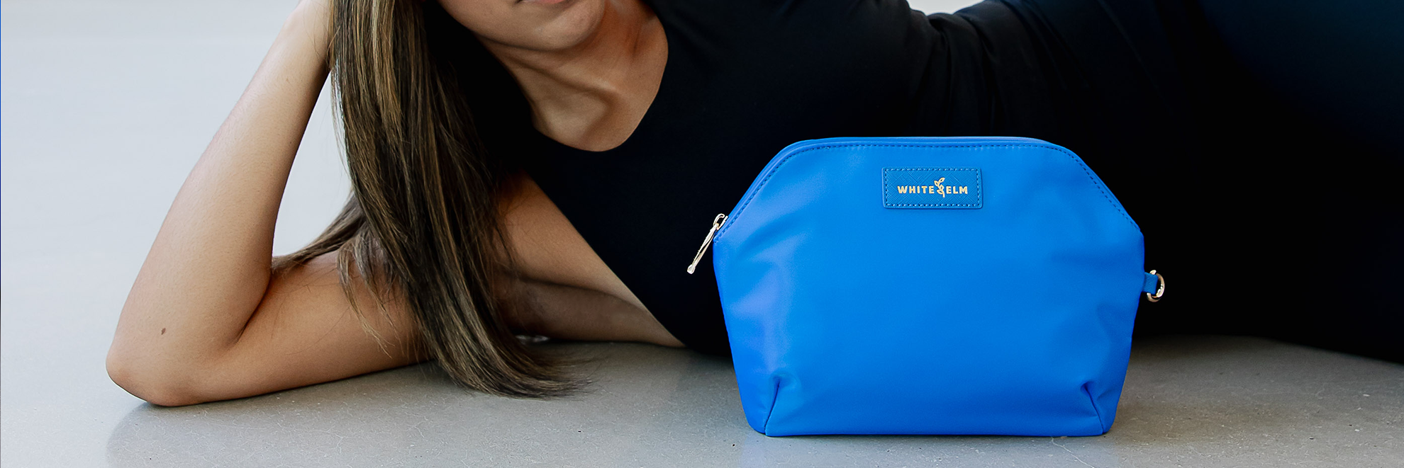 blue wet waterproof sandy bag by white elm on floor by model