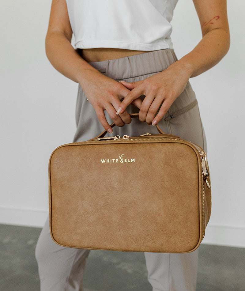 Close-up detail of the Almond Aven Travel Train Case's hardware and texture