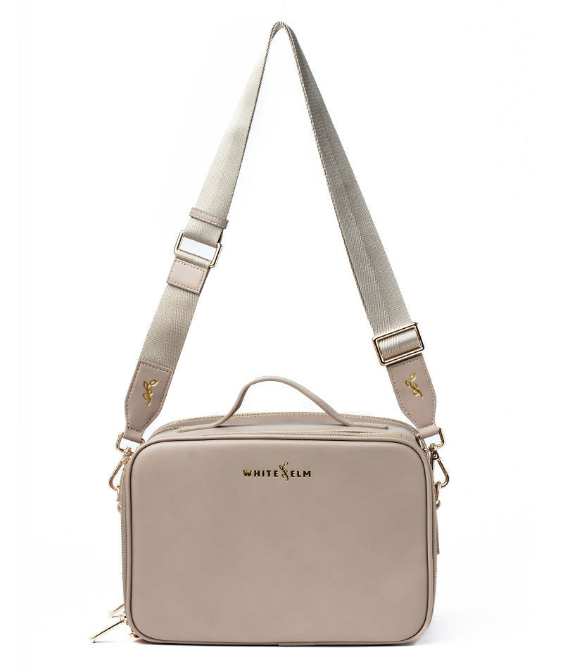 Taupe Aven Travel Train Case with premium hardware, studio product shot (gold hardware)