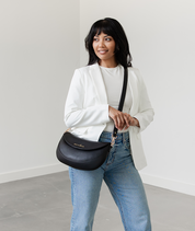 Woman wearing the Black Emily Crescent bag crossbody