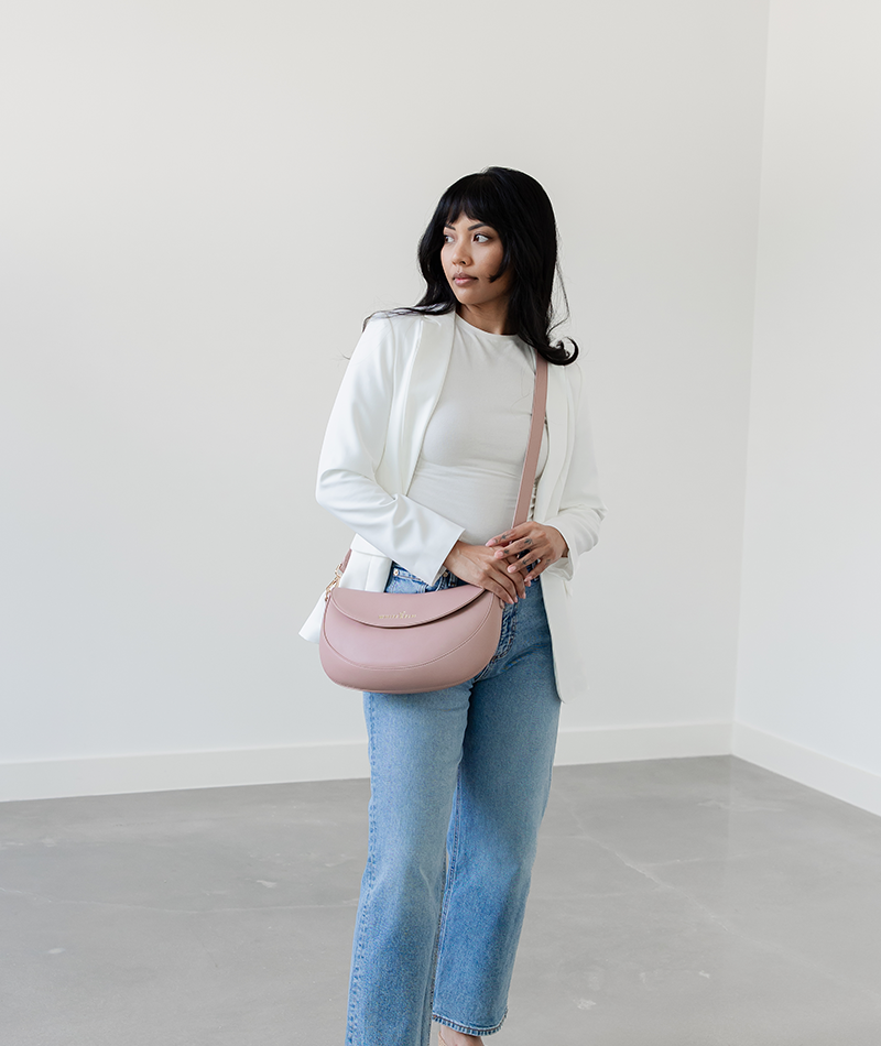 Woman wearing the Dusty Rose Emily Crescent bag crossbody