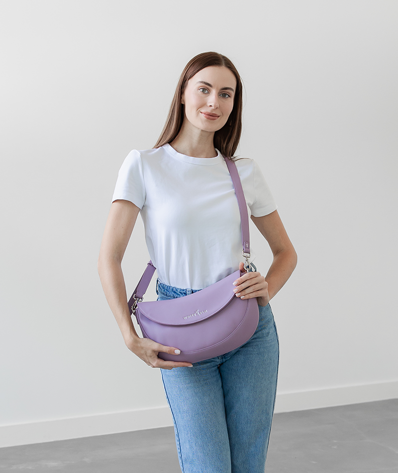 Woman wearing the Heather Purple Emily Crescent bag crossbody