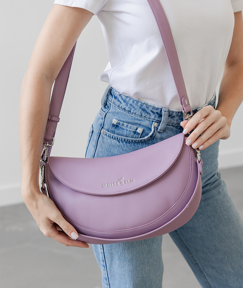 Woman wearing the Heather Purple Emily Crescent bag over the shoulder