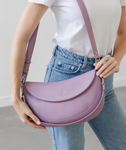 Woman wearing the Heather Purple Emily Crescent bag over the shoulder