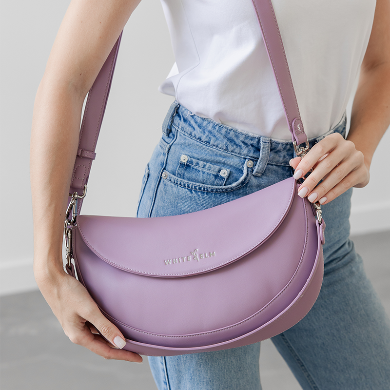 Woman wearing the Heather Purple Emily Crescent bag over the shoulder