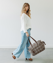 Woman walking with the Uptown Check wool Gemini convertible backpack
