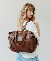 Walnut Gemini convertible backpack worn on one shoulder