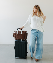 Walnut Gemini convertible backpack slipped over a suitcase handle with the luggage sleeve
