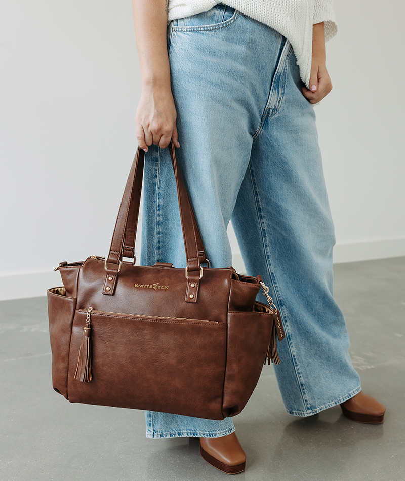 Walnut Gemini convertible backpack carried by the top handles