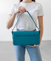 Back panel of the teal Noemi shoulder bag with silver hardware
