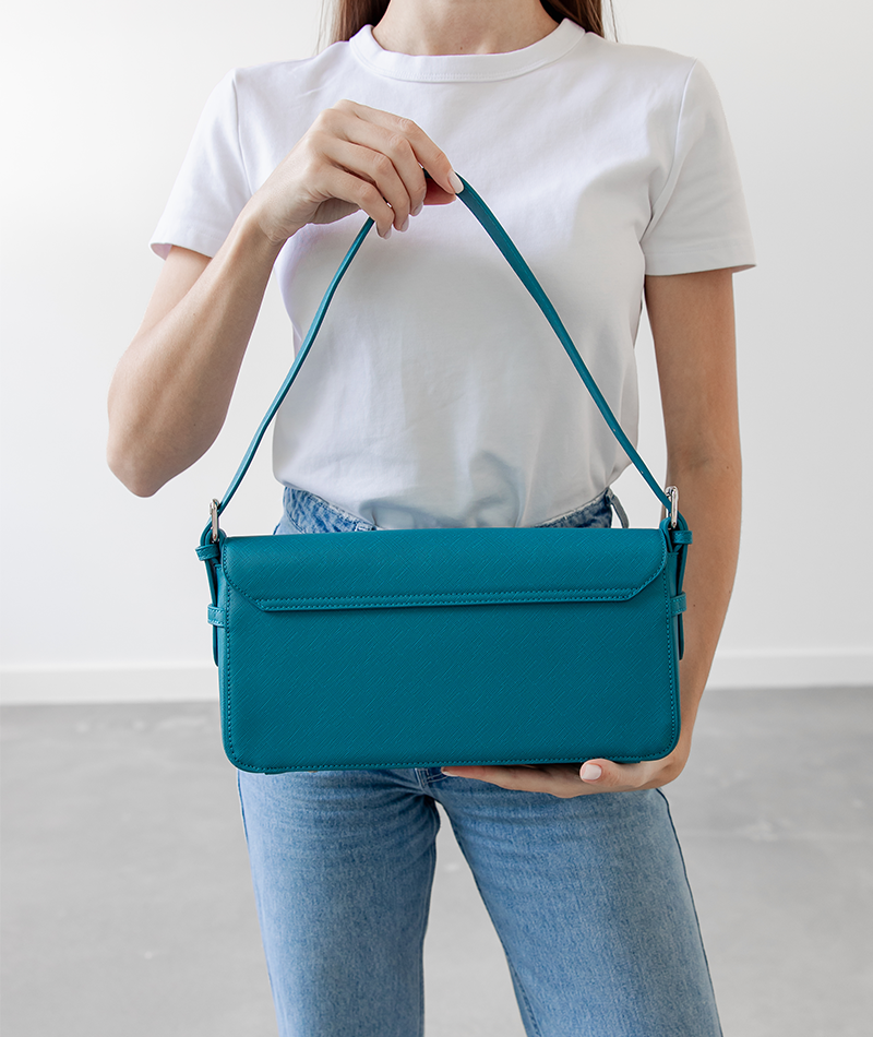 Back panel of the teal Noemi shoulder bag with silver hardware