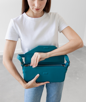 Close-up of the zipper pocket on the teal Noemi shoulder bag