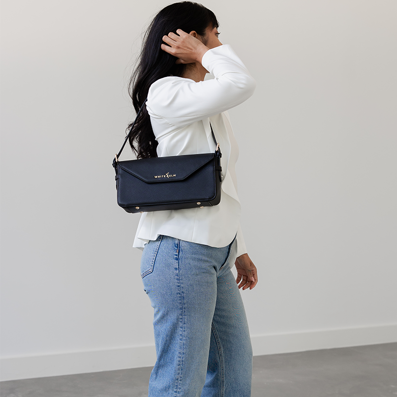Black Noemi shoulder bag worn over the shoulder, side view