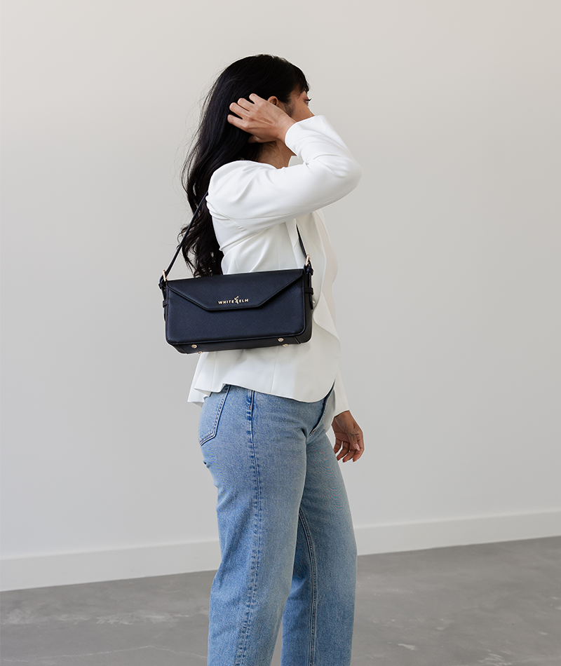 Black Noemi shoulder bag worn over the shoulder, side view