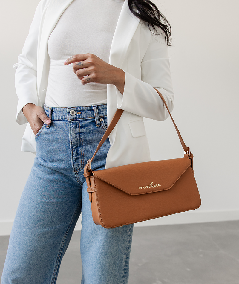 Maple Noemi shoulder bag draped over the forearm near the hip