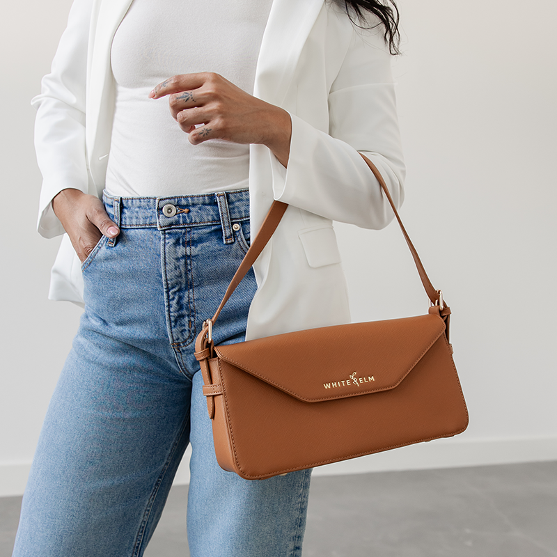 Caramel Noemi shoulder bag draped over the forearm near the hip