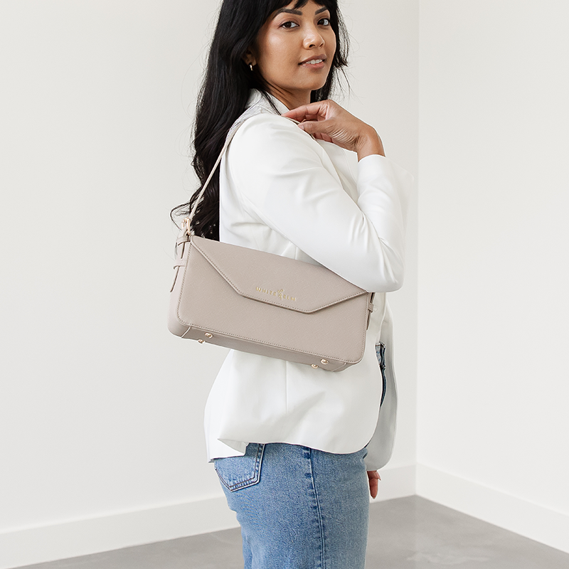 Taupe Noemi shoulder bag worn over the shoulder, looking back