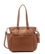 A caramel-colored tote bag made from vegan leather with gold hardware, featuring a structured design with a top zipper, and carrying handles.