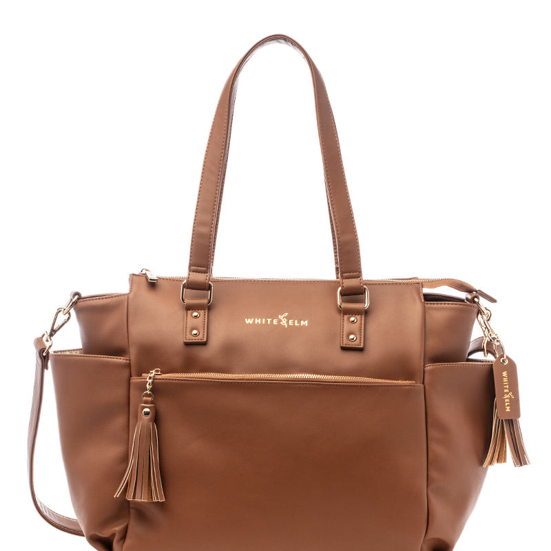 A brown Gemini convertible backpack with multiple compartments and an adjustable strap, displayed against a plain background.
