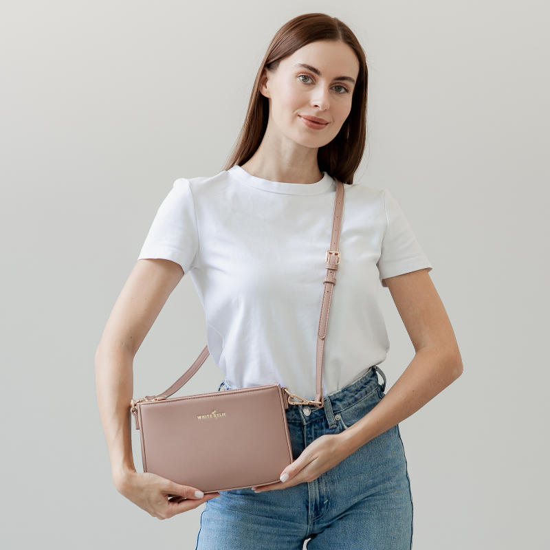 Dusty Rose Ara Convertible Crossbody Clutch worn over the shoulder with the long strap